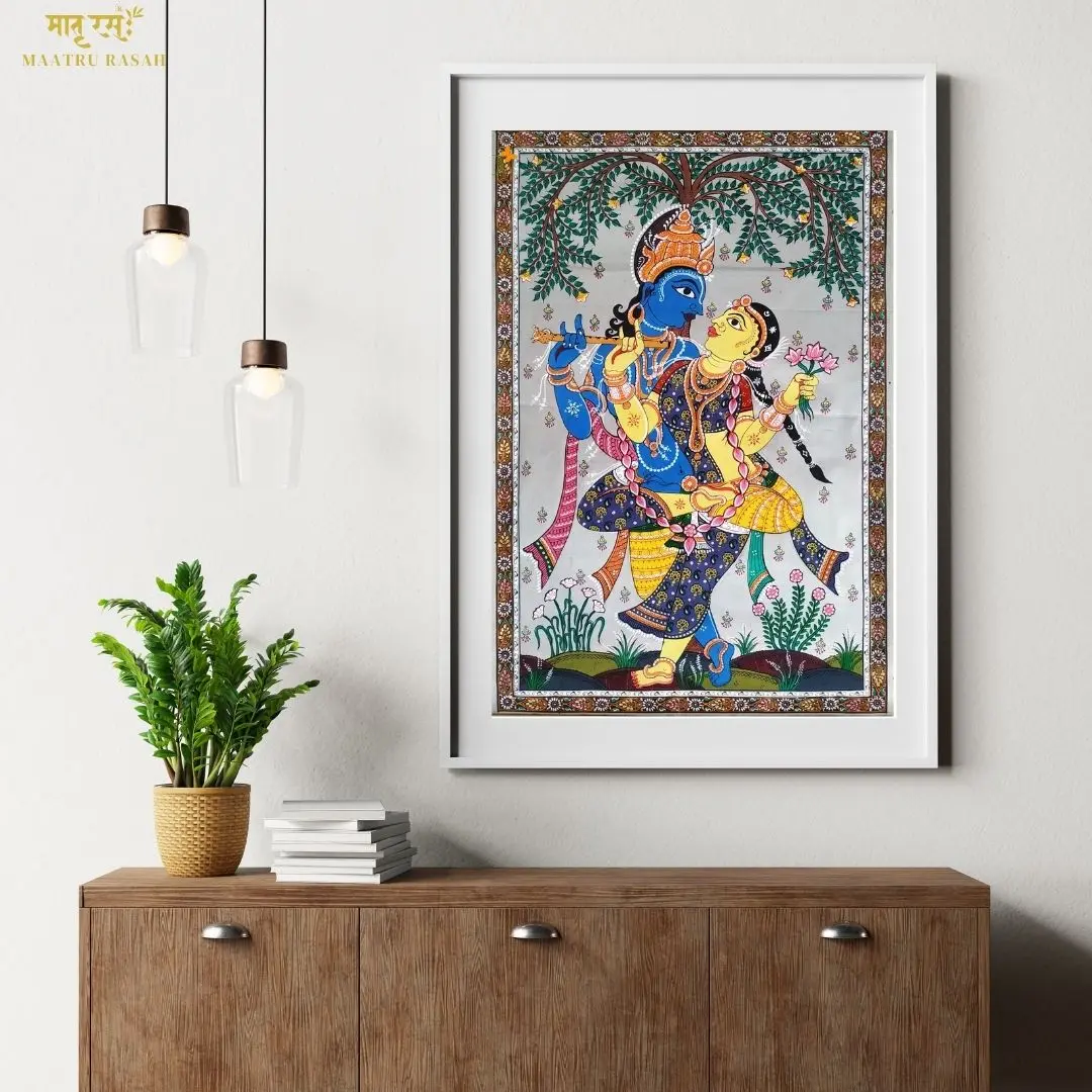 Buy Pattachitra Paintings Online | GI Tagged Odisha Wall Art – Maatru Rasah Framed Pattachitra painting of Radha Krishna on wall above wooden console – Maatru Rasah’s GI tagged traditional Indian art.