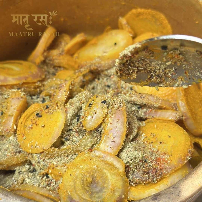 Fresh onions being mixed with spices for Pyaaz Rasah onion pickle